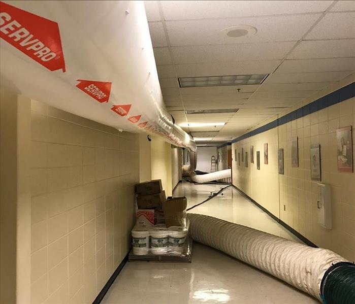 Drying ducts setup in a hallway of a school in Maury County